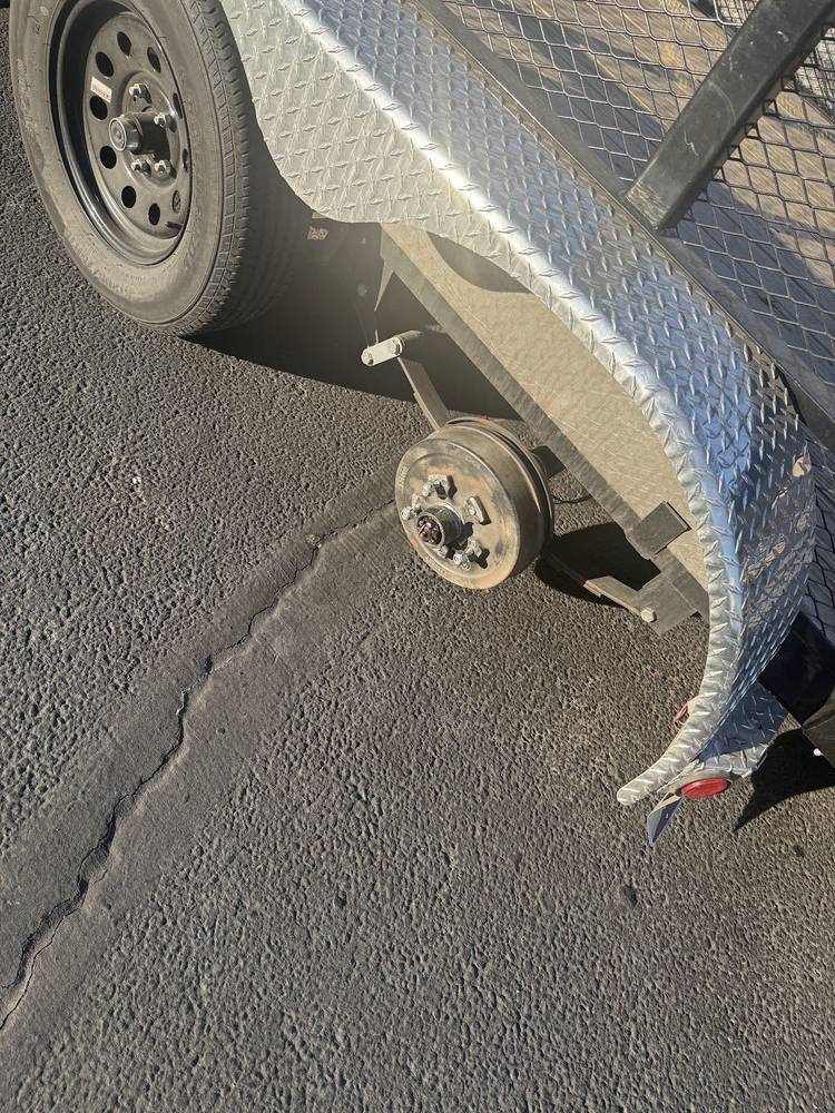 Trailer wheel and fender during axle repair